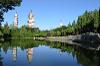 A photo of three pagodas taken from across a lake. There are two in the foreground and one in the background.