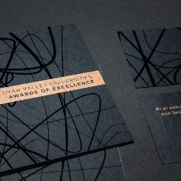 UVU's Awards of Excellence Invite on the ground