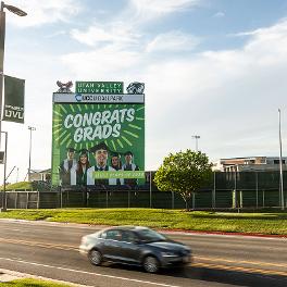 Congrats Grads sign next to a road