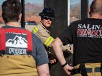 Firefighter instructing other firefighters