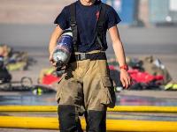 Firefighter walking with an oxygen tank