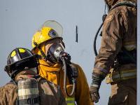 Three fire fighters talking with each other