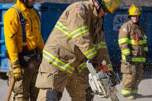 Firemen using a chainsaw