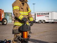 Firefighter standing with Hydraulic rescue tools