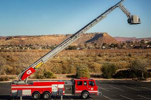 Firetruck with an extended ladder and bucket for people to stand in.