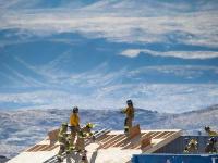 A group of firefighters cutting through plywood