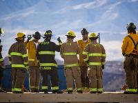 Firefighters standing in a group looking at mountains