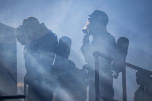 Firefighters in smoke with gear on