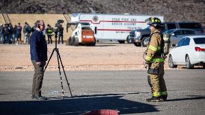 A cameraman recording a firefighter