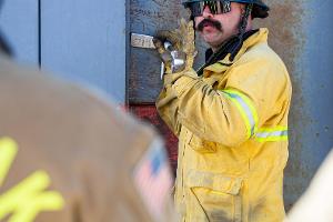 Firefighter instructing other firefighters