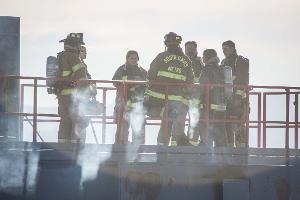 Group of firefighters standing on a building