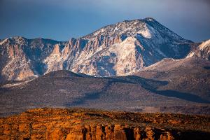 Red rocks with a mountain in the background