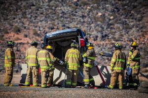 Firefighters gathered around a turned over van