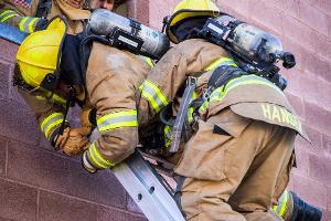 Firefighter training to rescuing another firefighter on a ladder