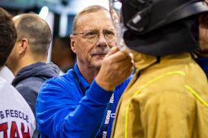 A man looking at a firefighter helmet