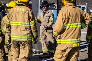A firefighter instructing other firefighters