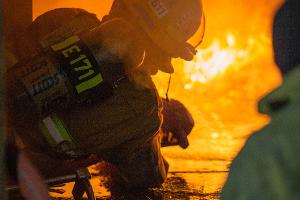 Firefighters shooting a fire with water