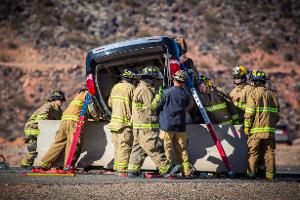 Firefighters gathered around a turned over van