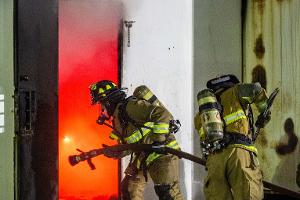 Firefighters entering burning building