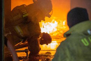 Firefighters shooting a fire with water