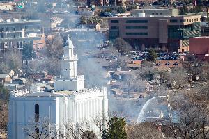 A white building with a smoke cloud next to it