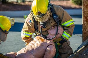 Firefighter treating a training dummy