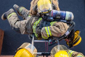 Firefighter training to rescuing another firefighter on a ladder