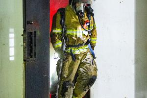 Firefighter exiting burning building