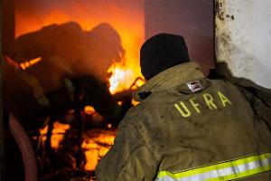 Firefighters shooting a fire with water