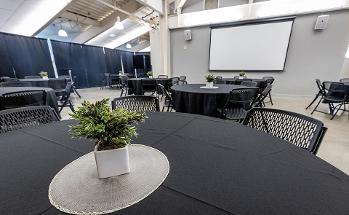 Skylight room with circular tables and chairs around the tables