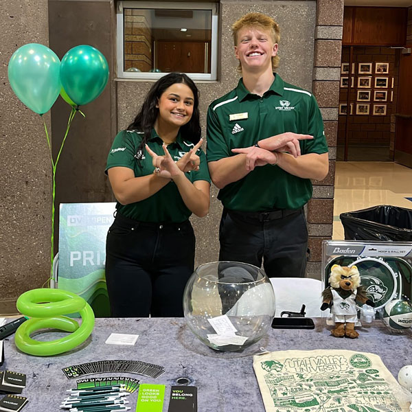 UVU ambassadors promoting UVU at an event