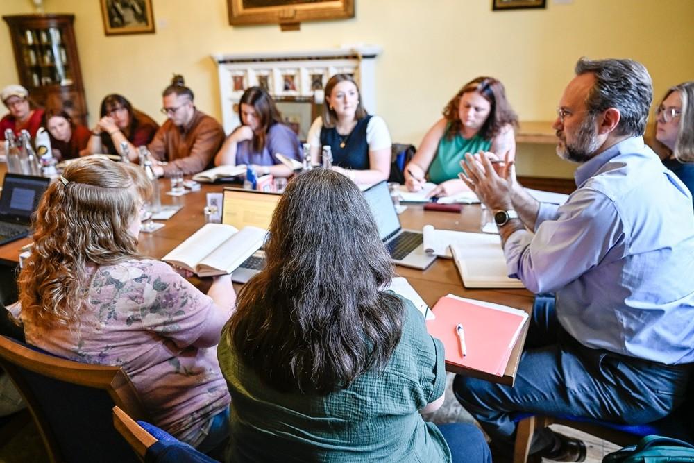 Dr. Bradford teaches MACGCL in a parlor class at Pembroke college.