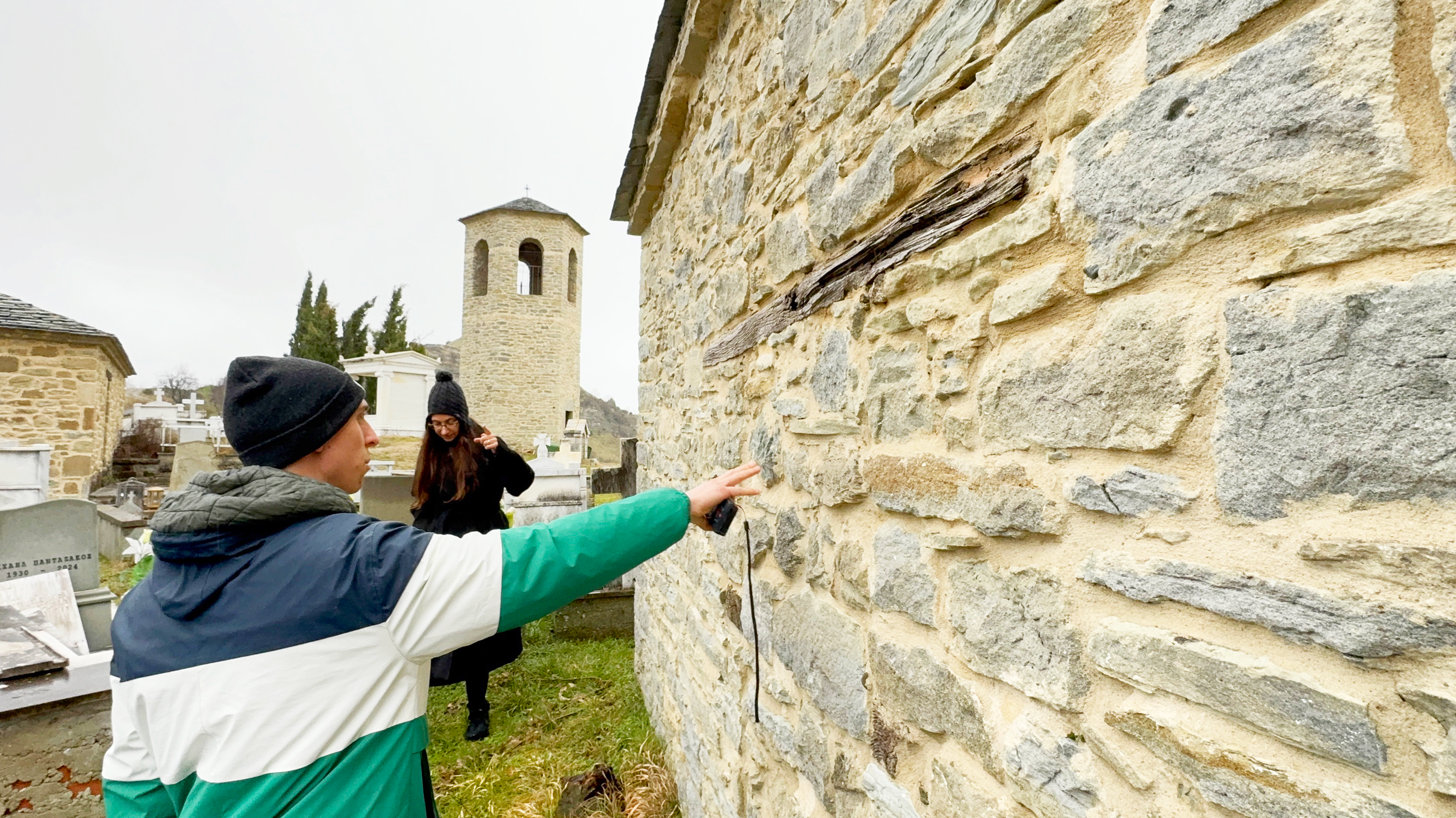 Person touching an outer wall in Greece
