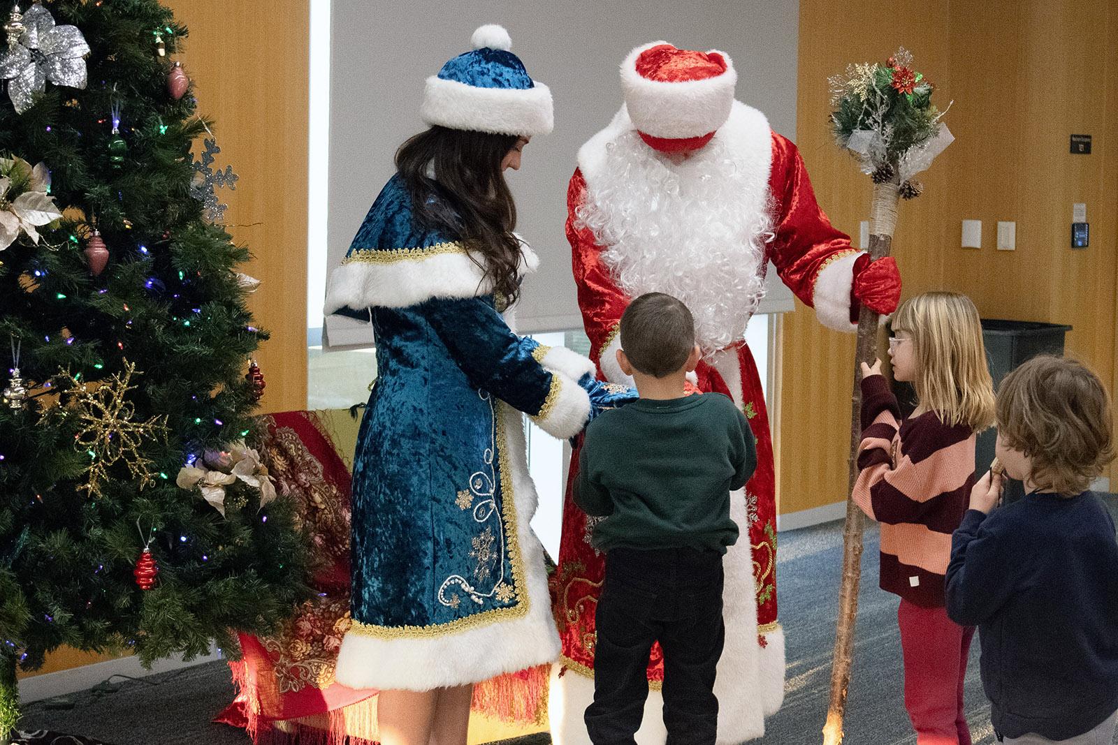 Ded Moroz and Snegurochka handing out presents