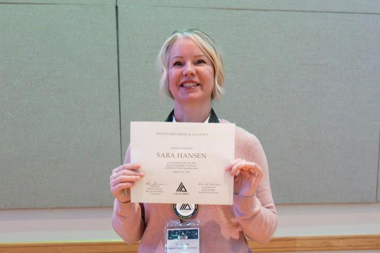 Counselor poses with award