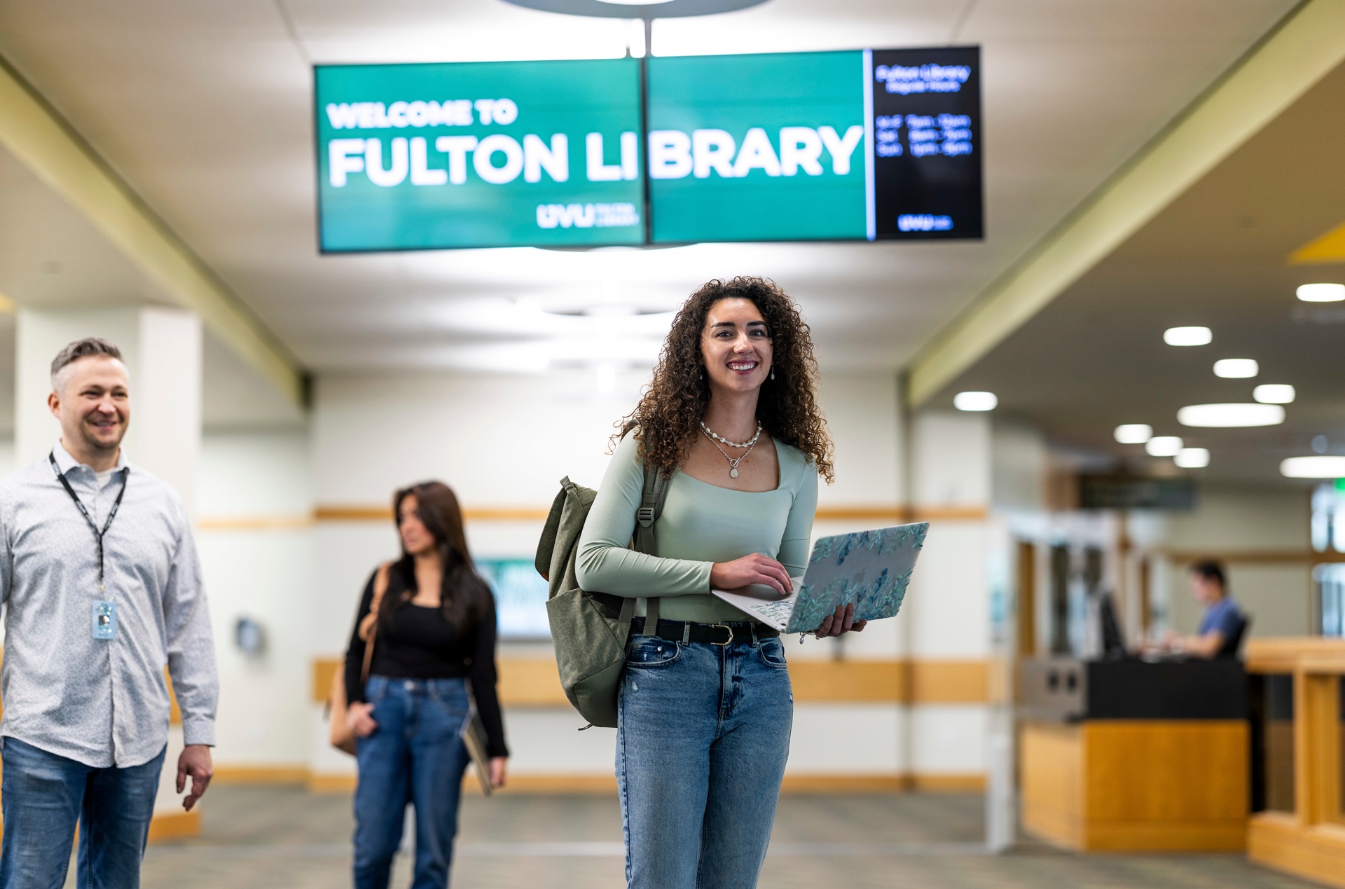 Student with a laptop at the library.
