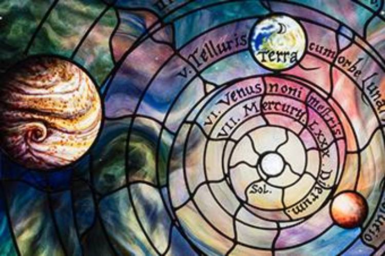 Roots of Knowledge - image of the stained glass with planets and bright colors