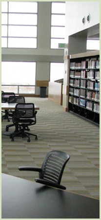 Image of stacks, tables, chairs, and windows at Fulton Library.
