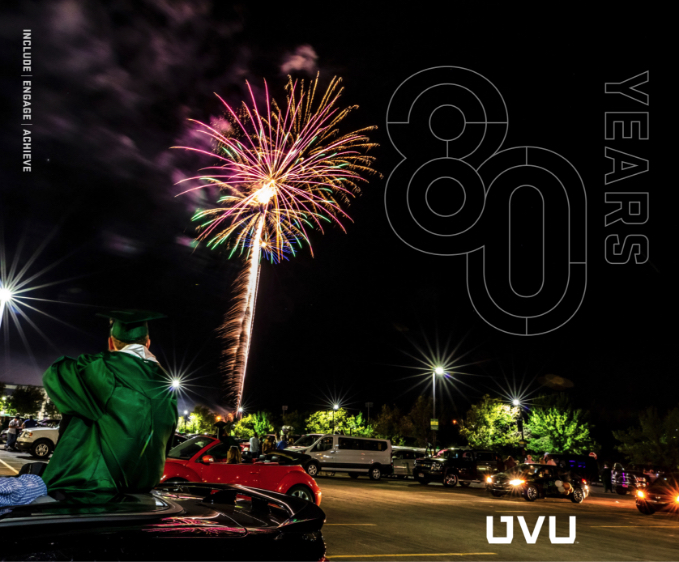 80th campaign graphics on image of night fireworks at parking lot graduation.