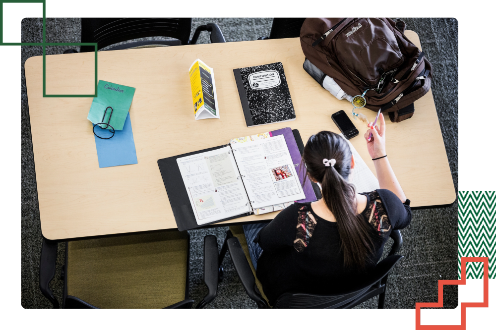student studying at a table on campus