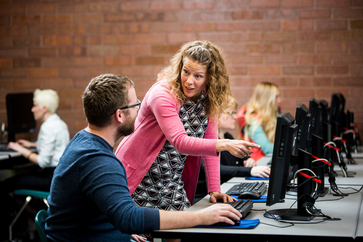 Teacher helping student