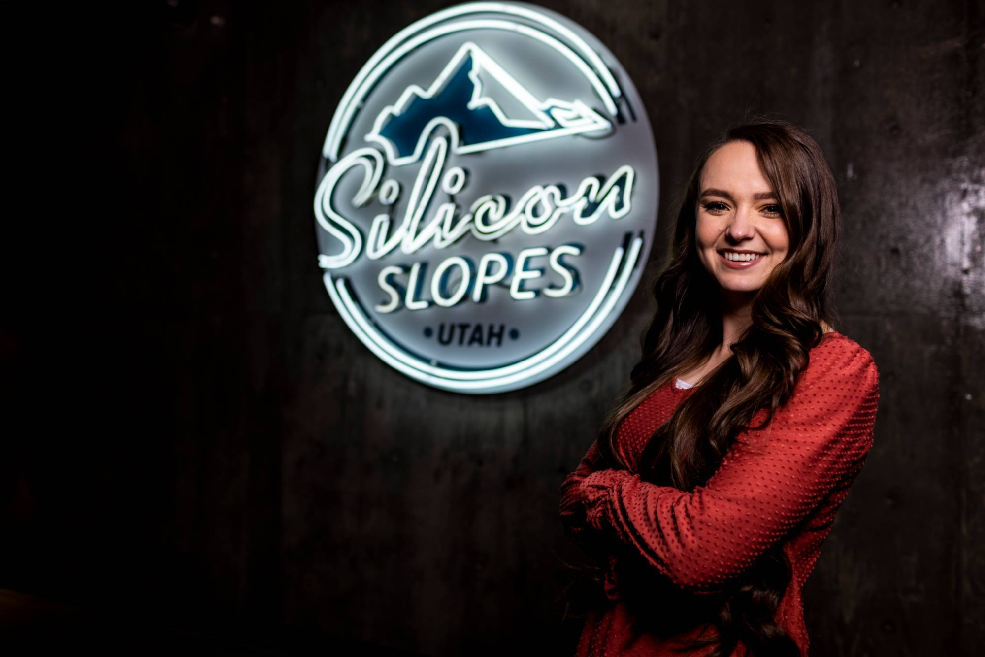 woman standing in front of Silicon Slopes logo