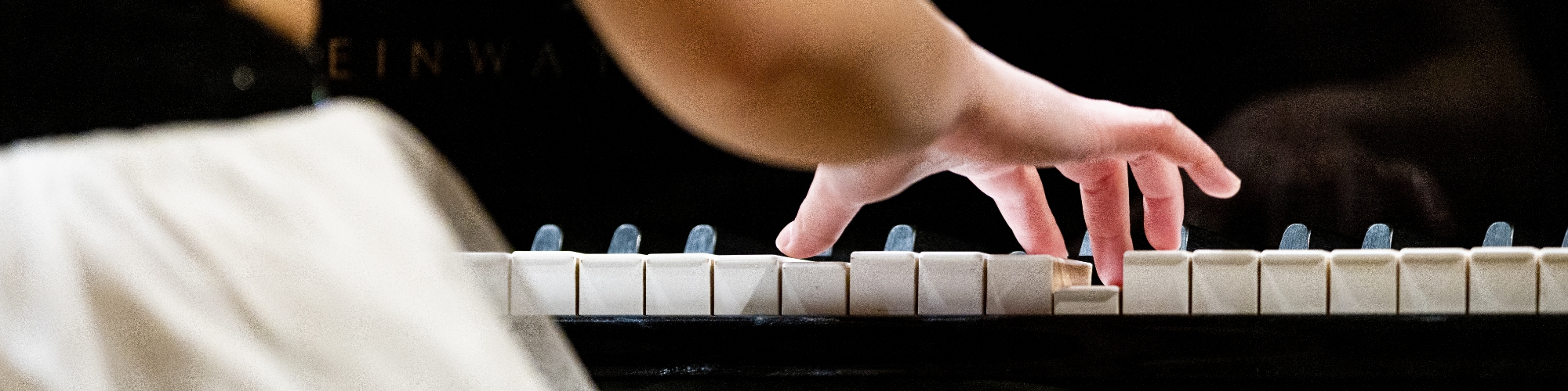 Student playing piano - decorative image