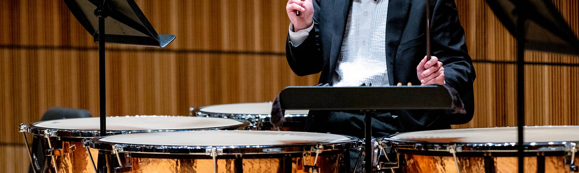 Student playing the timpani