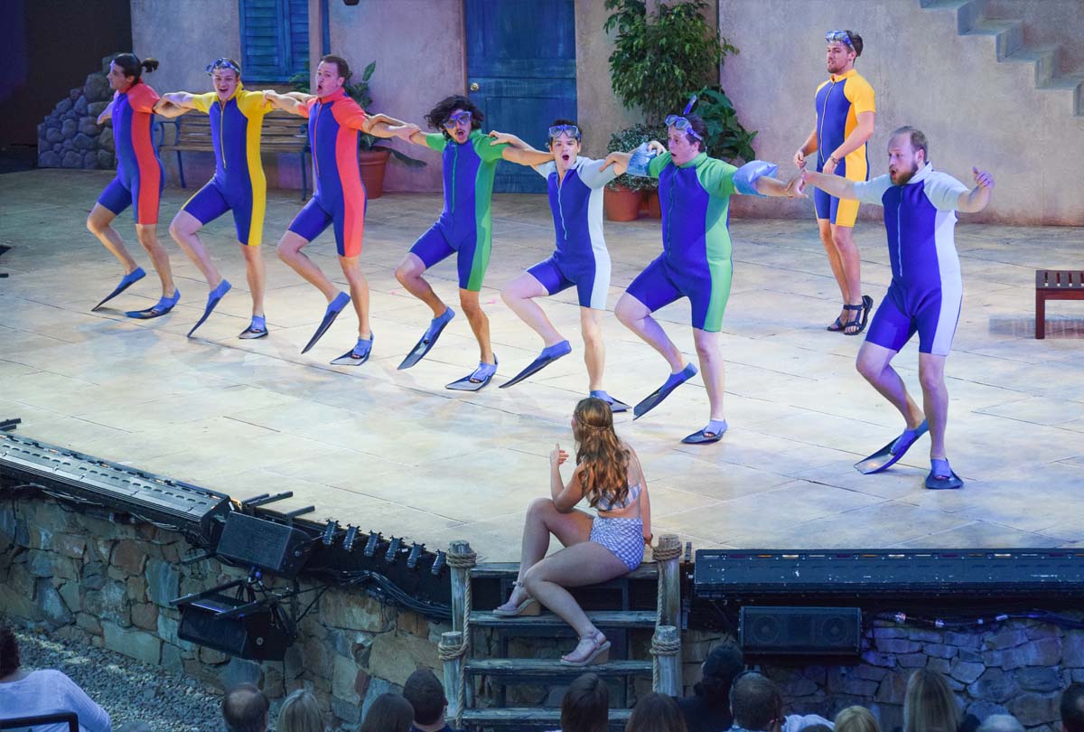 Mamma Mia ensemble dancing in flippers.