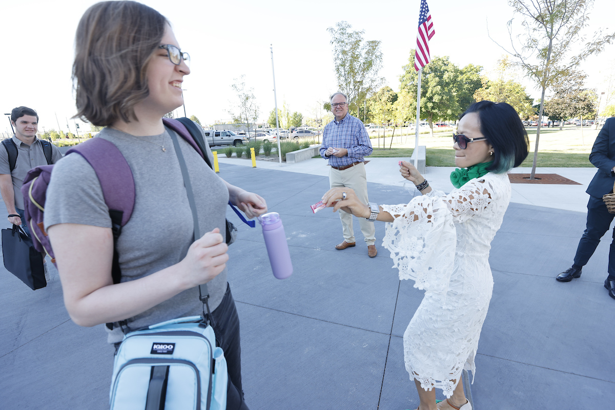 President Tuminez handing out snacks to students