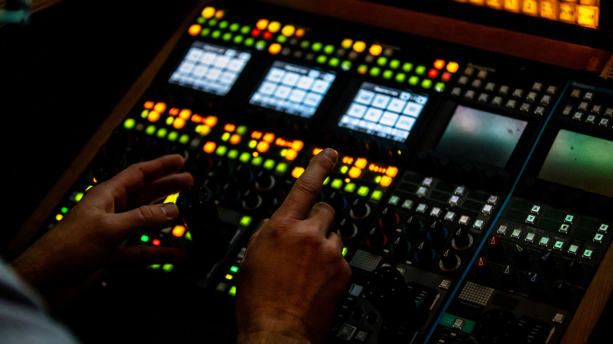 An image of hands above a switchboard