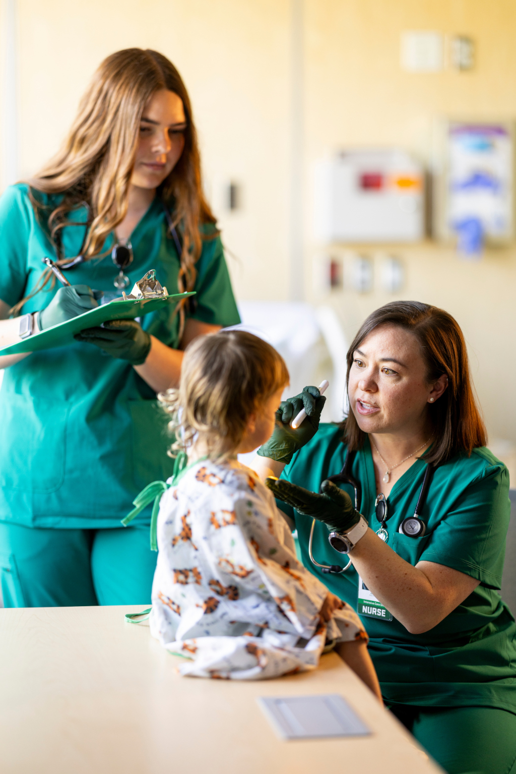 nurses examine a school-aged girl