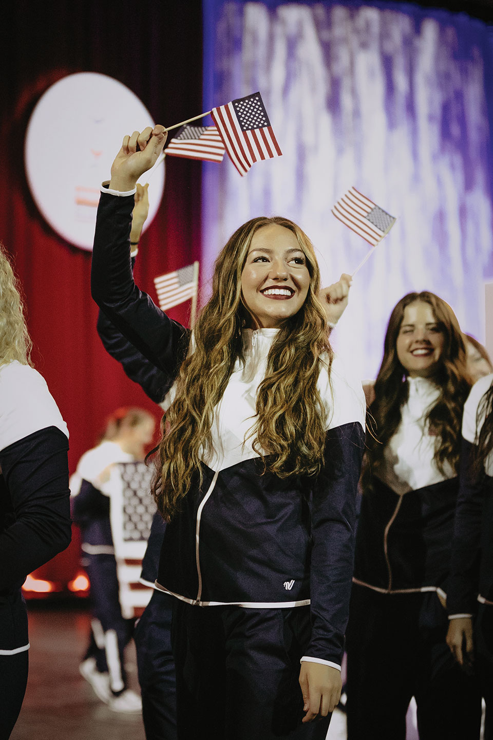 UVU dancer Taylor Williams waves an American flag during the ICU opening ceremonies