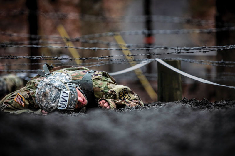 Crawling under barbed wire.